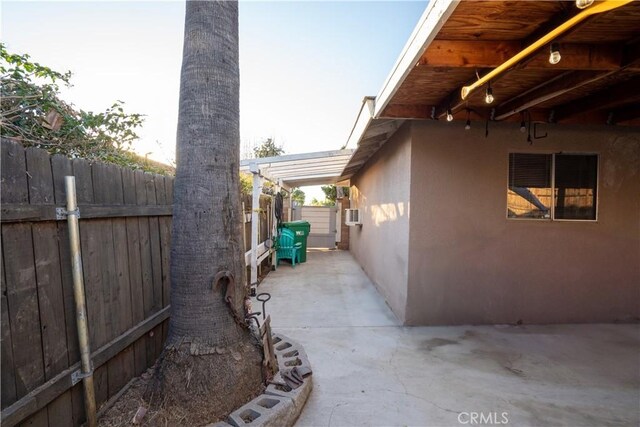 view of side of property with a patio