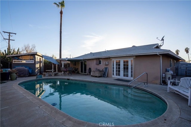 view of pool featuring a patio area, a grill, and french doors