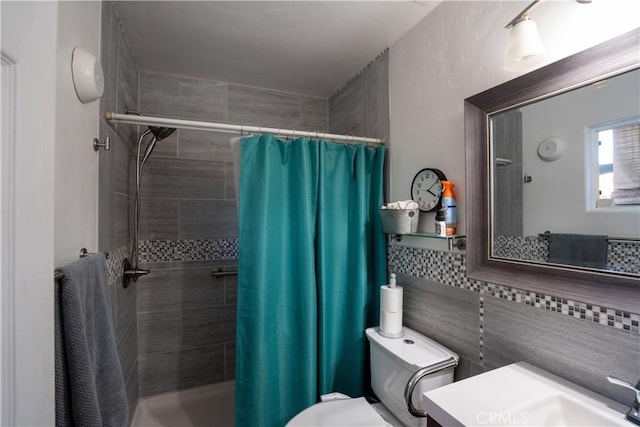 bathroom with toilet, vanity, a shower with curtain, and tile walls