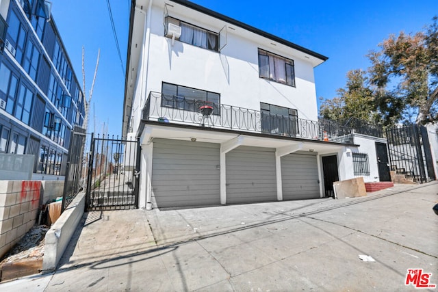 exterior space featuring a balcony and a garage