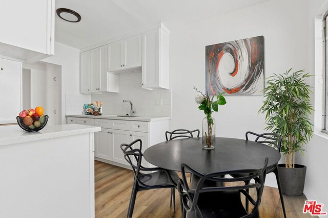 dining area featuring sink and light hardwood / wood-style flooring