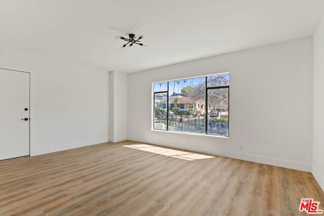 spare room featuring light wood-type flooring