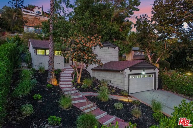 obstructed view of property with a garage