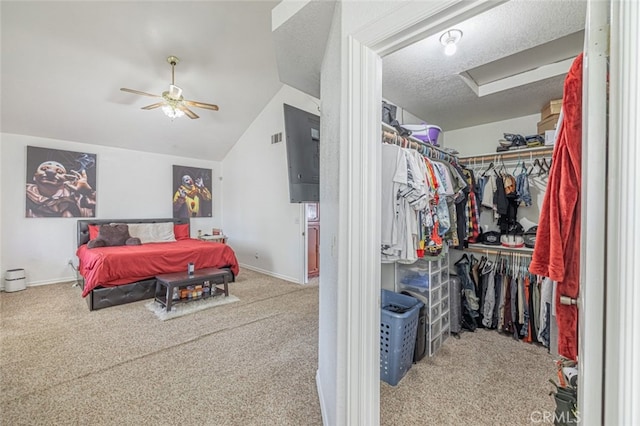 bedroom featuring ceiling fan, a closet, lofted ceiling, light colored carpet, and a textured ceiling