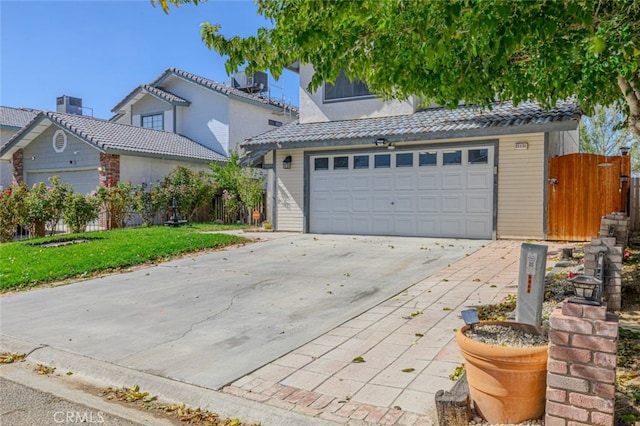 view of property with a front yard and a garage