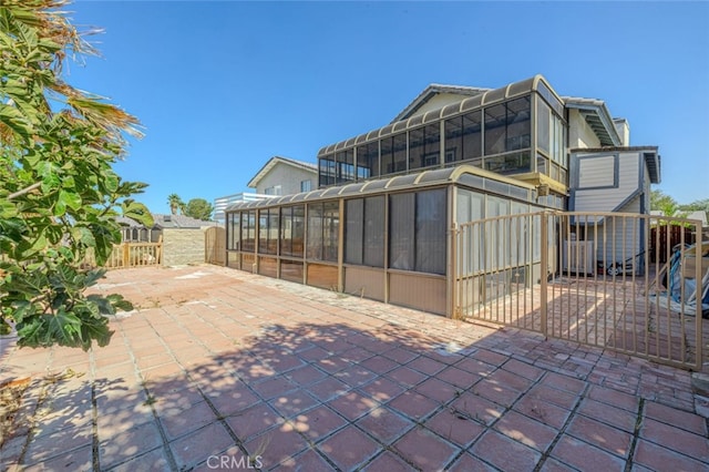 view of patio / terrace featuring a sunroom