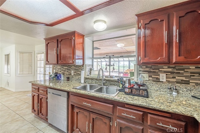 kitchen with backsplash, dishwasher, sink, and light stone counters