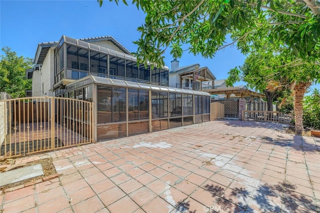 view of patio / terrace featuring a sunroom