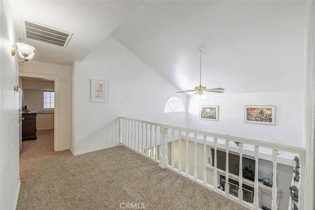 hall with carpet flooring and lofted ceiling