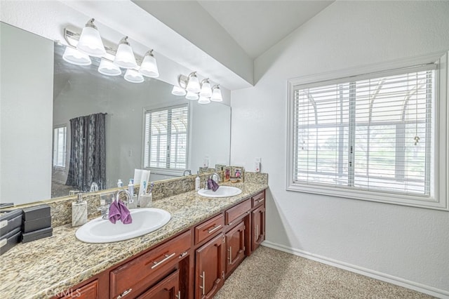 bathroom featuring vanity and vaulted ceiling