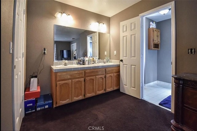 full bath featuring carpet floors, double vanity, and a sink