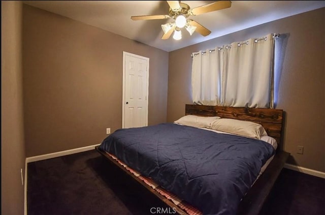 bedroom with ceiling fan, baseboards, and dark carpet