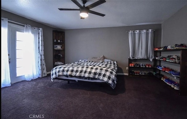 bedroom featuring dark carpet, a ceiling fan, and baseboards