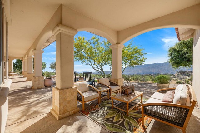 view of patio / terrace with an outdoor hangout area and a mountain view