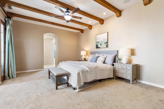 carpeted bedroom featuring ceiling fan and beam ceiling