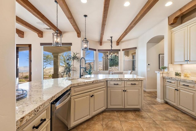 kitchen with stainless steel dishwasher, a notable chandelier, sink, and pendant lighting