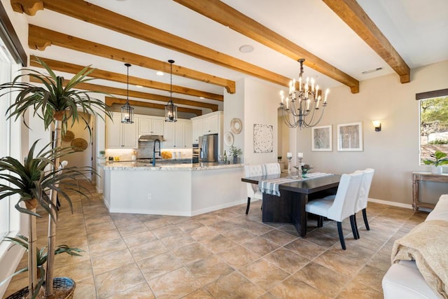 dining area featuring beamed ceiling and an inviting chandelier