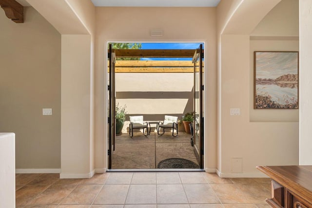 doorway to outside with light tile patterned flooring