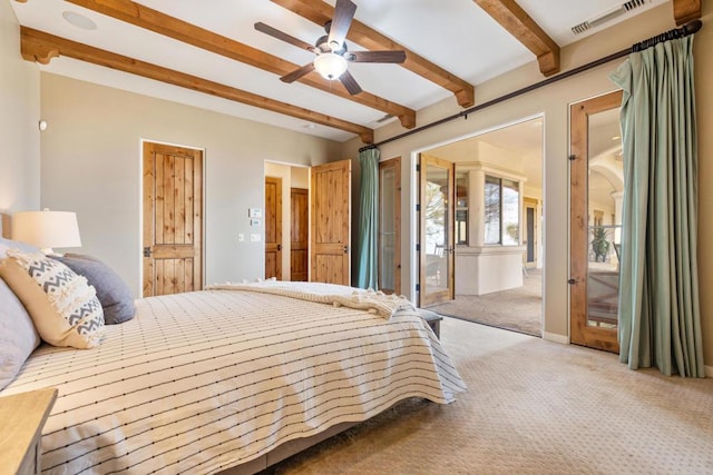 carpeted bedroom featuring ceiling fan and beam ceiling