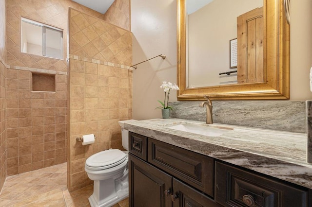 bathroom with toilet, vanity, and tile patterned flooring