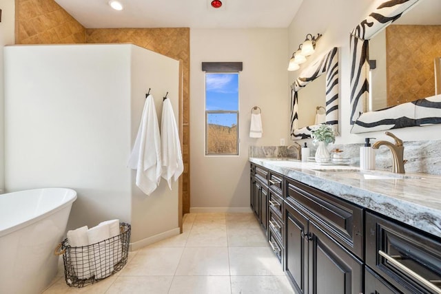 bathroom with vanity, tile patterned flooring, and a washtub