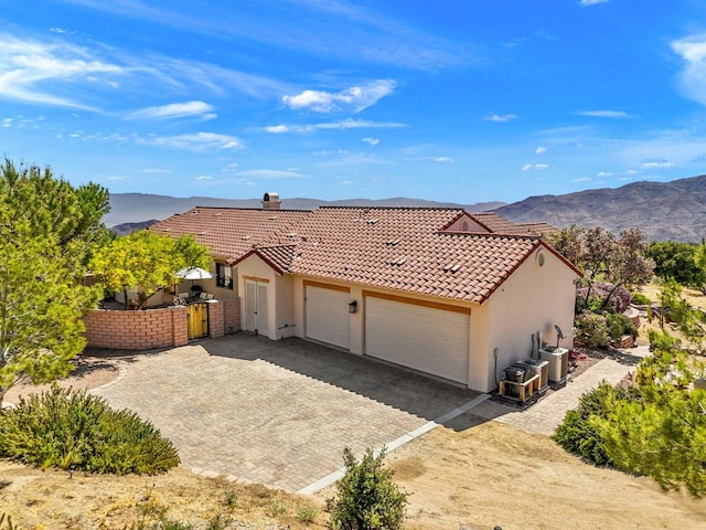 view of front of home featuring a mountain view and a garage