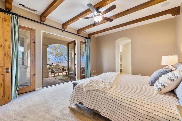 bedroom with ceiling fan, access to exterior, carpet flooring, and beamed ceiling