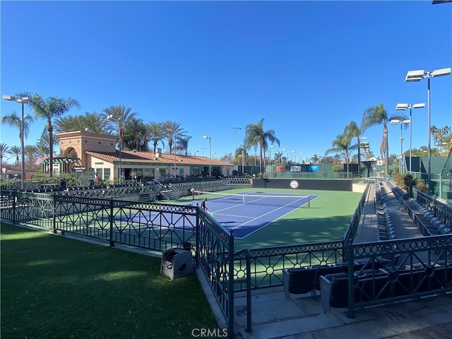 view of tennis court featuring fence