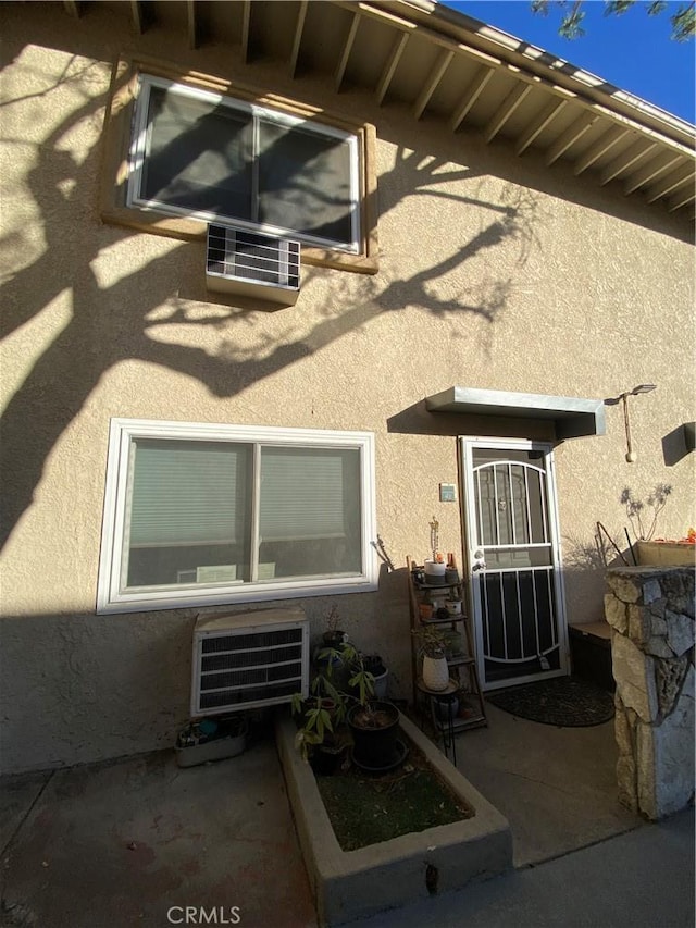 property entrance with heating unit and a patio area