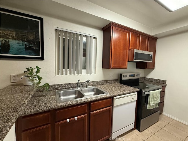 kitchen featuring appliances with stainless steel finishes, sink, and light tile patterned floors