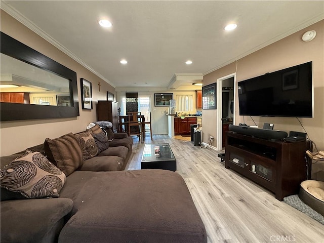 living area featuring ornamental molding, recessed lighting, and light wood-style floors