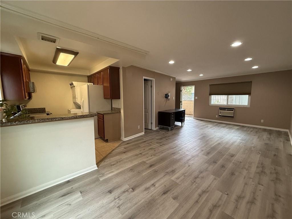 1620 N San Fernando Blvd Unit 48, Burbank, CA 91504 - kitchen with light wood-style floors, open floor plan, visible vents, and an AC wall unit