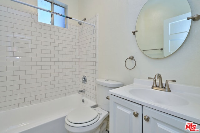 full bathroom with toilet, tiled shower / bath combo, and vanity