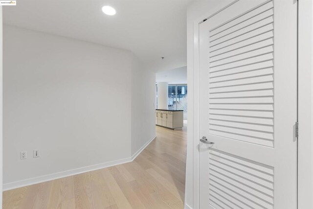 corridor with light hardwood / wood-style floors