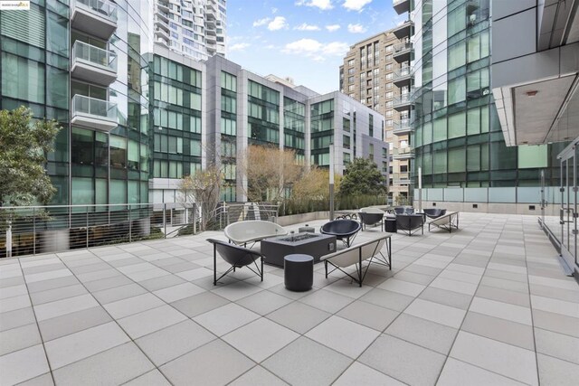 view of home's community featuring an outdoor fire pit and a patio