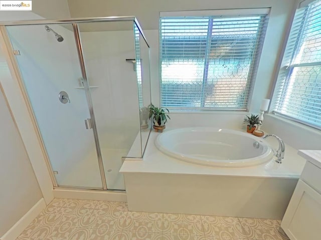 bathroom with tile patterned floors, vanity, and separate shower and tub