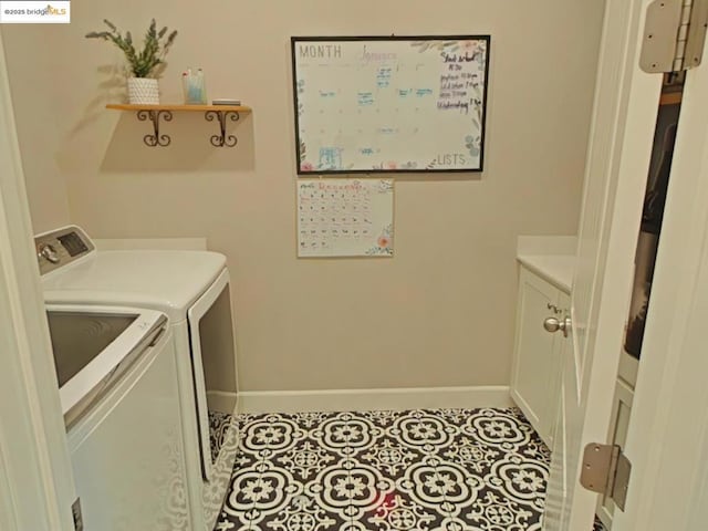 washroom with washer and dryer and light tile patterned floors