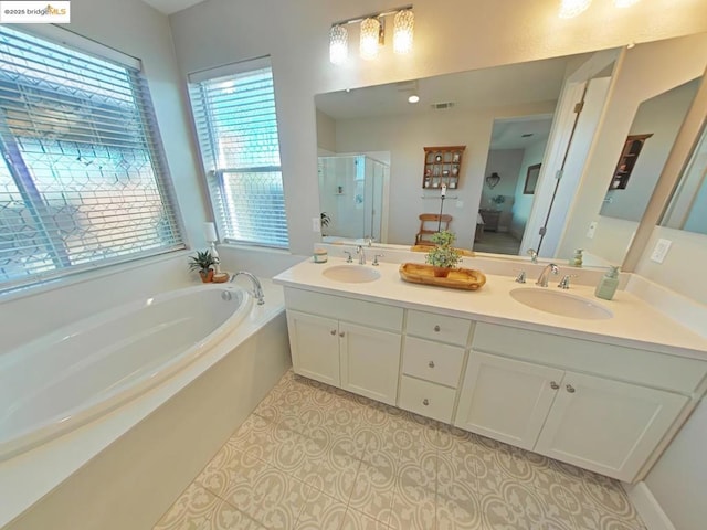 bathroom featuring separate shower and tub, vanity, and tile patterned flooring