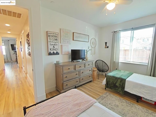 bedroom featuring ceiling fan and light hardwood / wood-style flooring