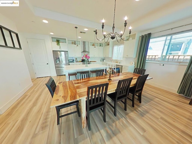 dining area featuring a chandelier and light hardwood / wood-style flooring