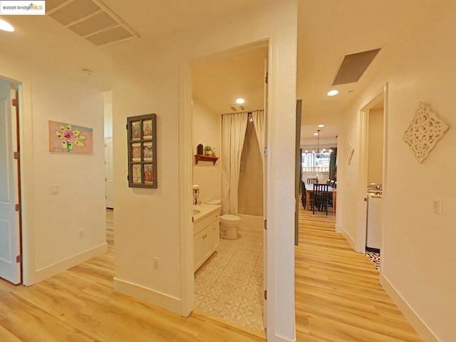 hall with light hardwood / wood-style flooring