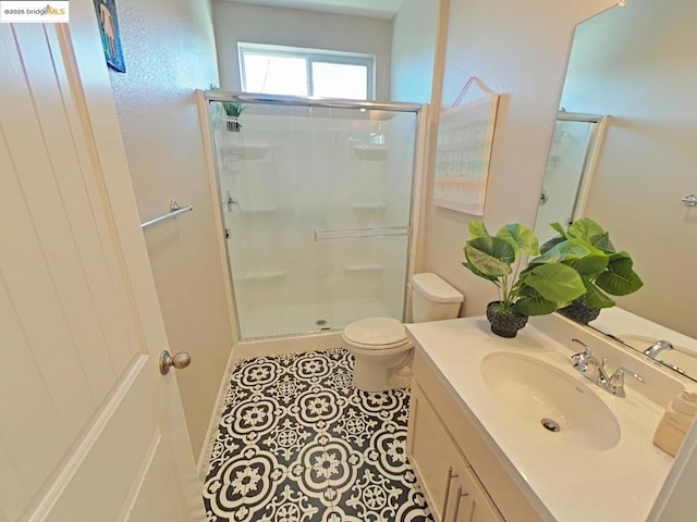 bathroom with toilet, tile patterned flooring, a shower with door, and vanity