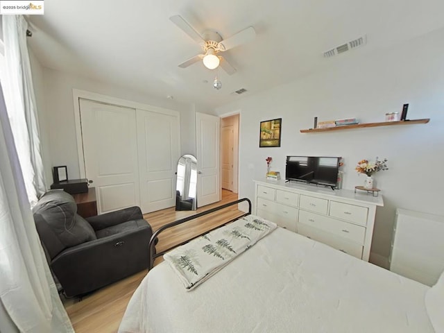 bedroom featuring light wood-type flooring, a closet, and ceiling fan