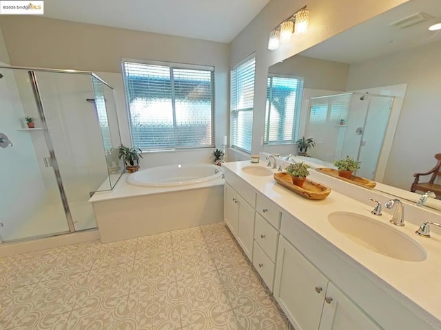 bathroom with tile patterned flooring, shower with separate bathtub, and vanity