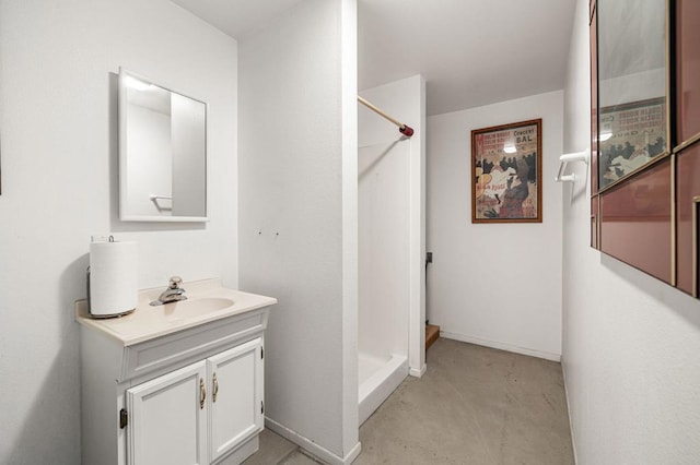 bathroom with a shower, vanity, and concrete floors