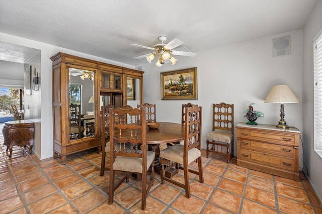 tiled dining space featuring ceiling fan and a healthy amount of sunlight