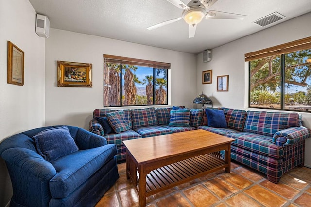 tiled living room with ceiling fan