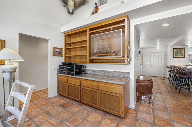 kitchen featuring tile patterned floors and a textured ceiling