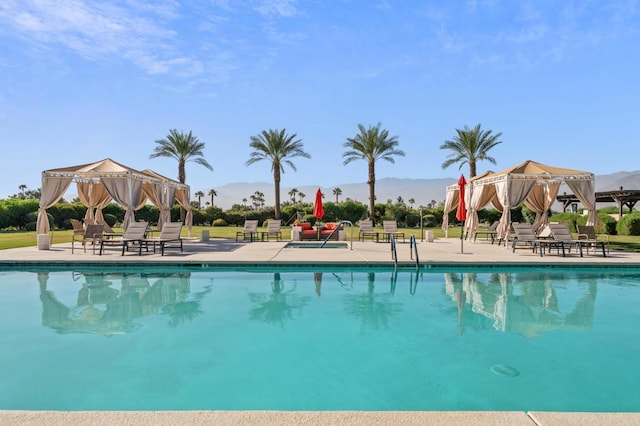 view of swimming pool with a patio area and a mountain view