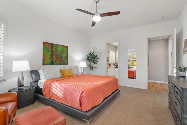 carpeted bedroom featuring ceiling fan and connected bathroom